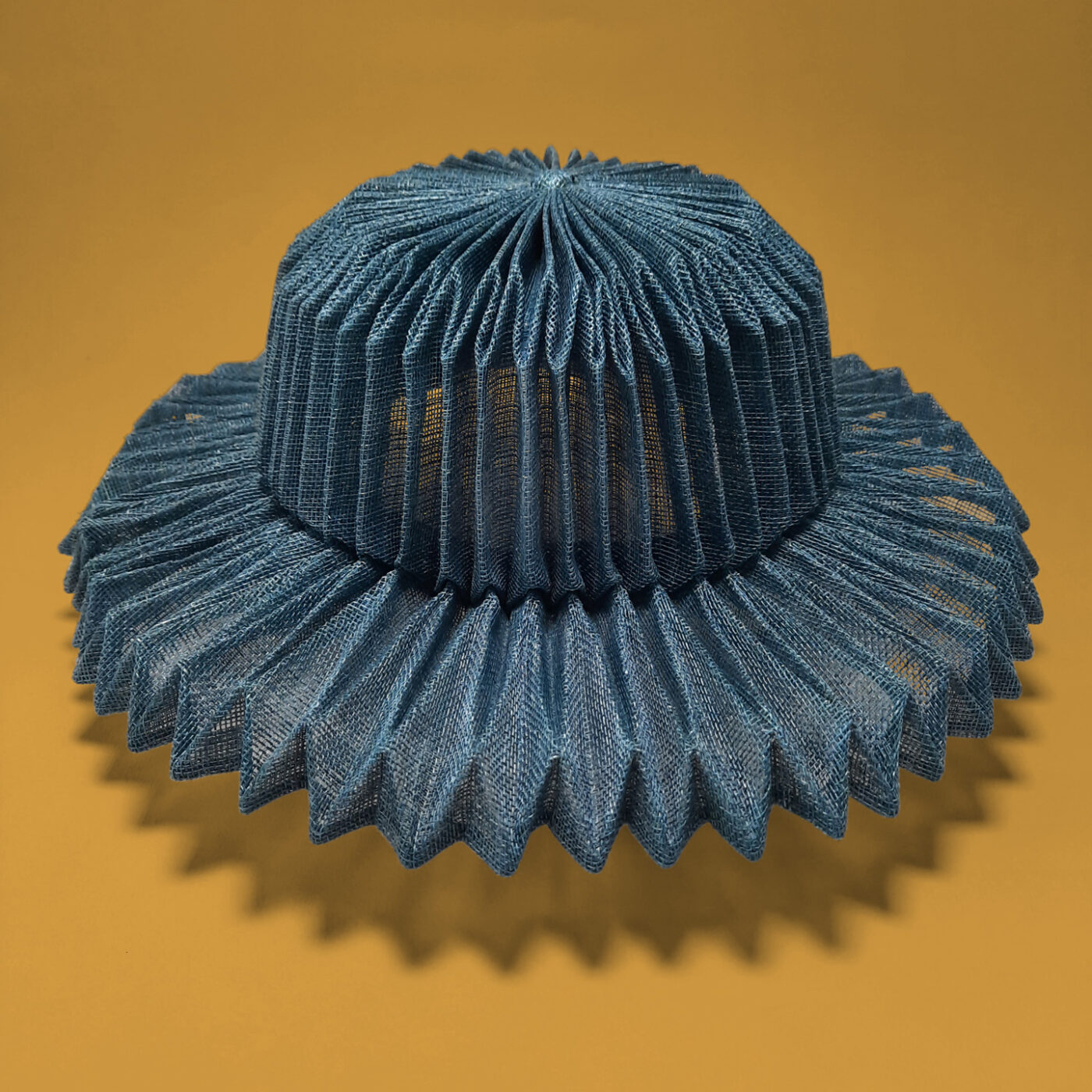 An one of a kind hat which is actually a wearable art. It's all pleated using origami which makes it the coolest summer hat.