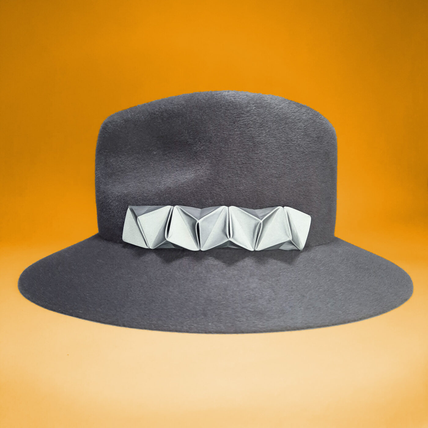 Grey velour felt fedora with a reflective chameleon detail that can be easily changed to customize your hat in a few seconds.