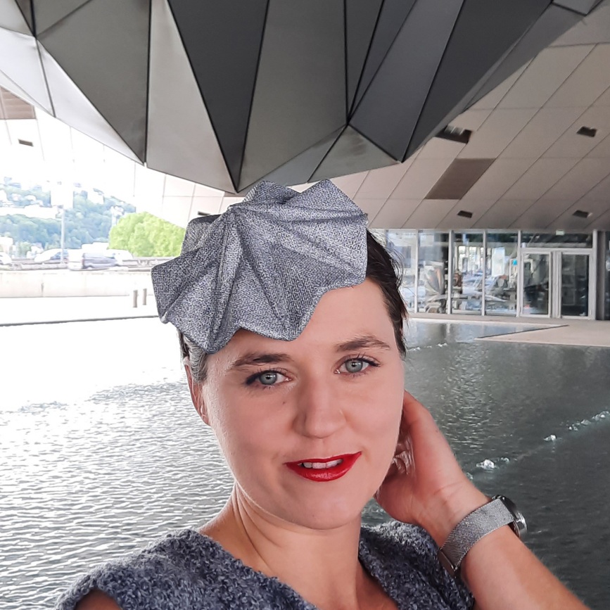 Fusanna the hatmaker in a reversible fascinator. The silver metallic side of this head jewel suits chic minimalist looks.